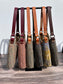 Side view of Harris Tweed® Rhode River Shoulder Bags six bags, with different prints and leather combos paired with Antique Brass Hardware. Handcrafted in Maryland
