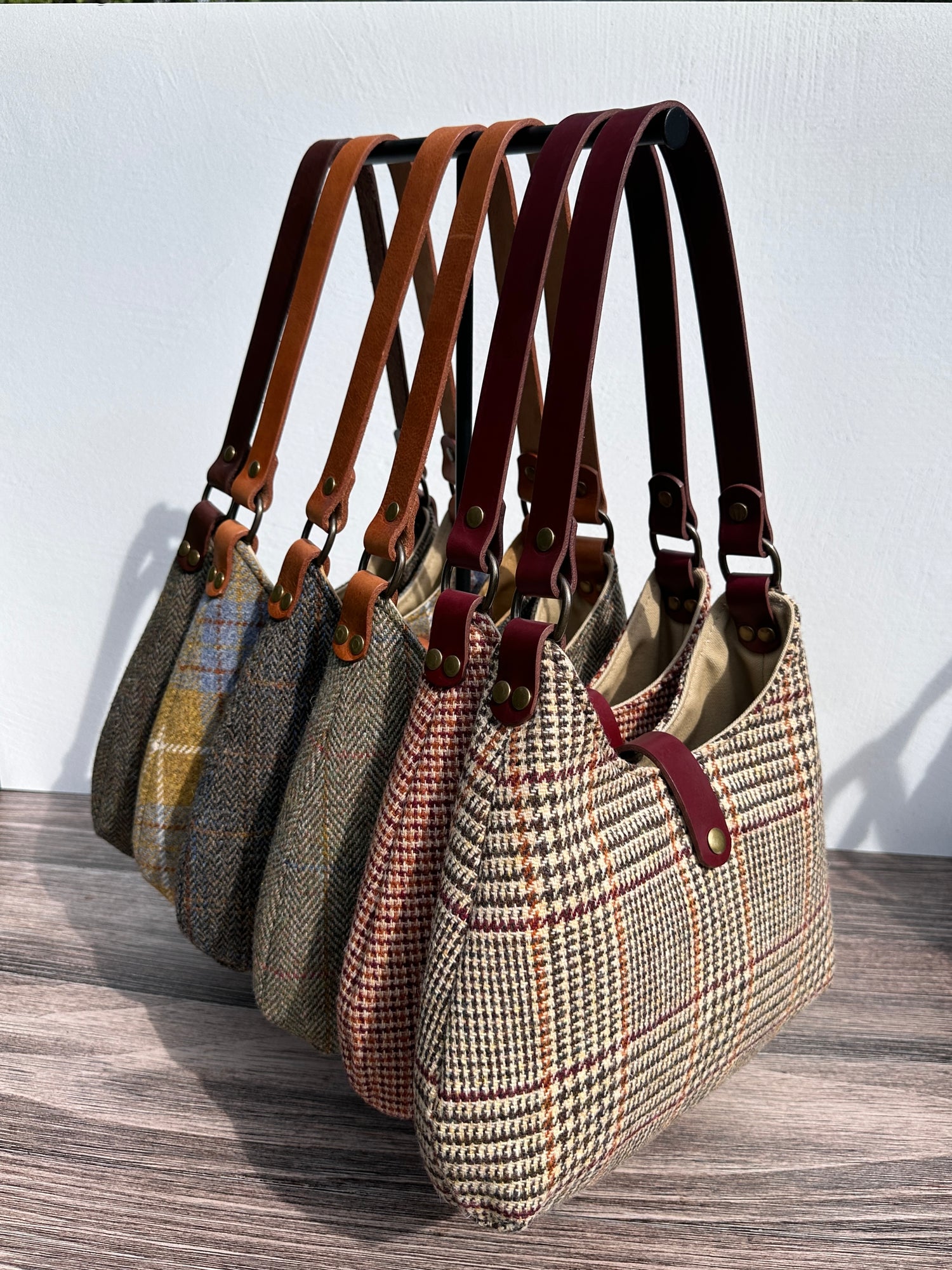 Harris Tweed® Rhode River Shoulder Bags six bags, with different prints and leather combos paired with Antique Brass Hardware. Handcrafted in Maryland