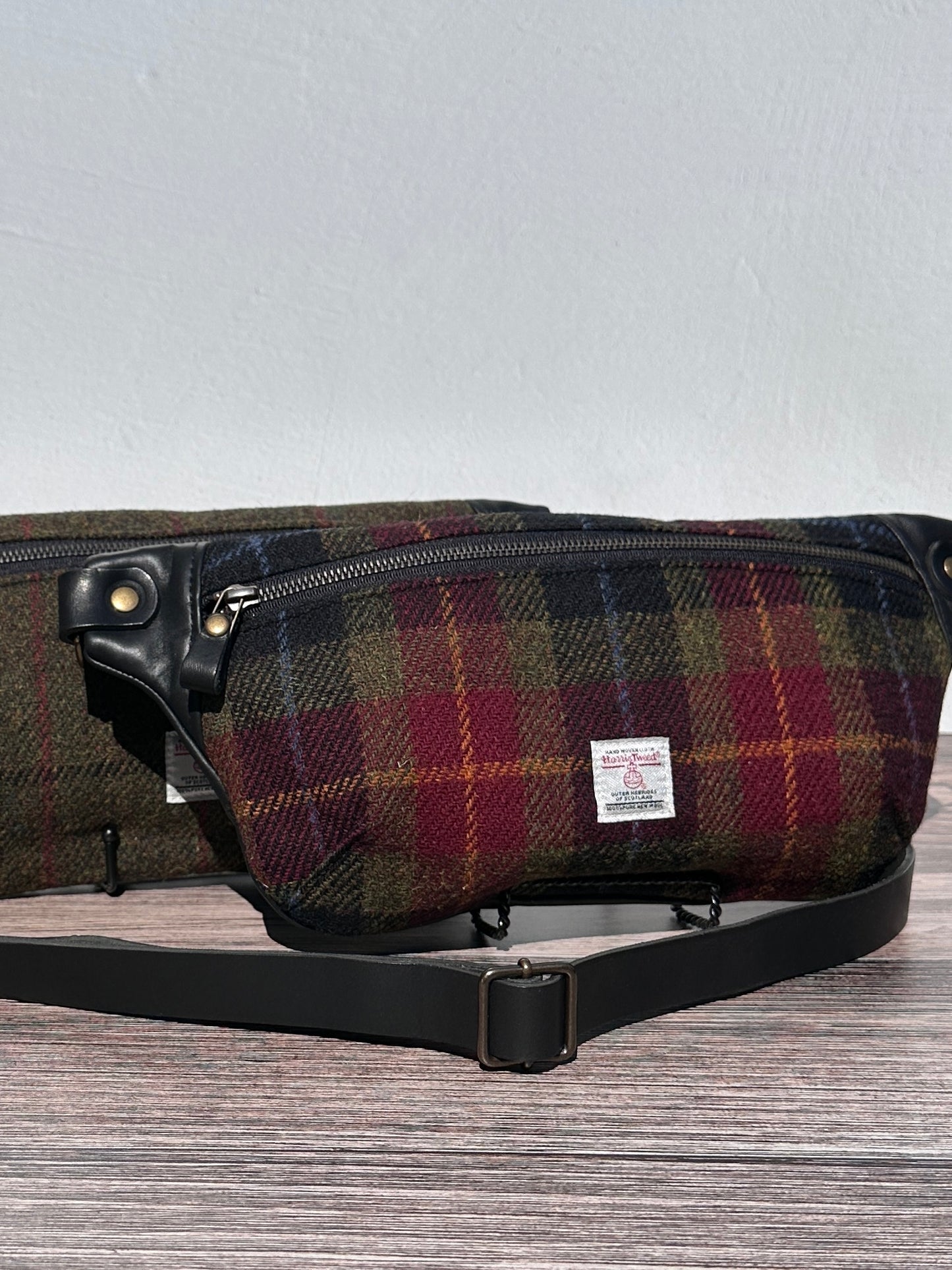 Luxury Green, Red and Black plaid Harris Tweed® and leather sling bag, handcrafted in Maryland with timeless design.