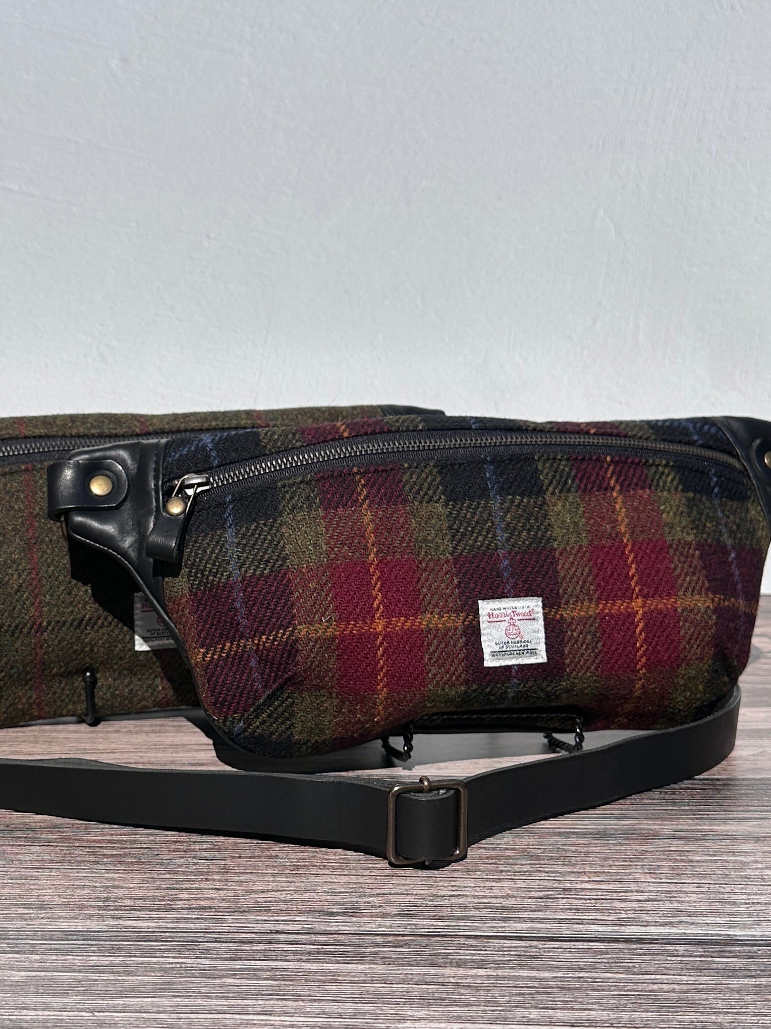 Luxury Green, Red and Black plaid Harris Tweed® and leather sling bag, handcrafted in Maryland with timeless design.