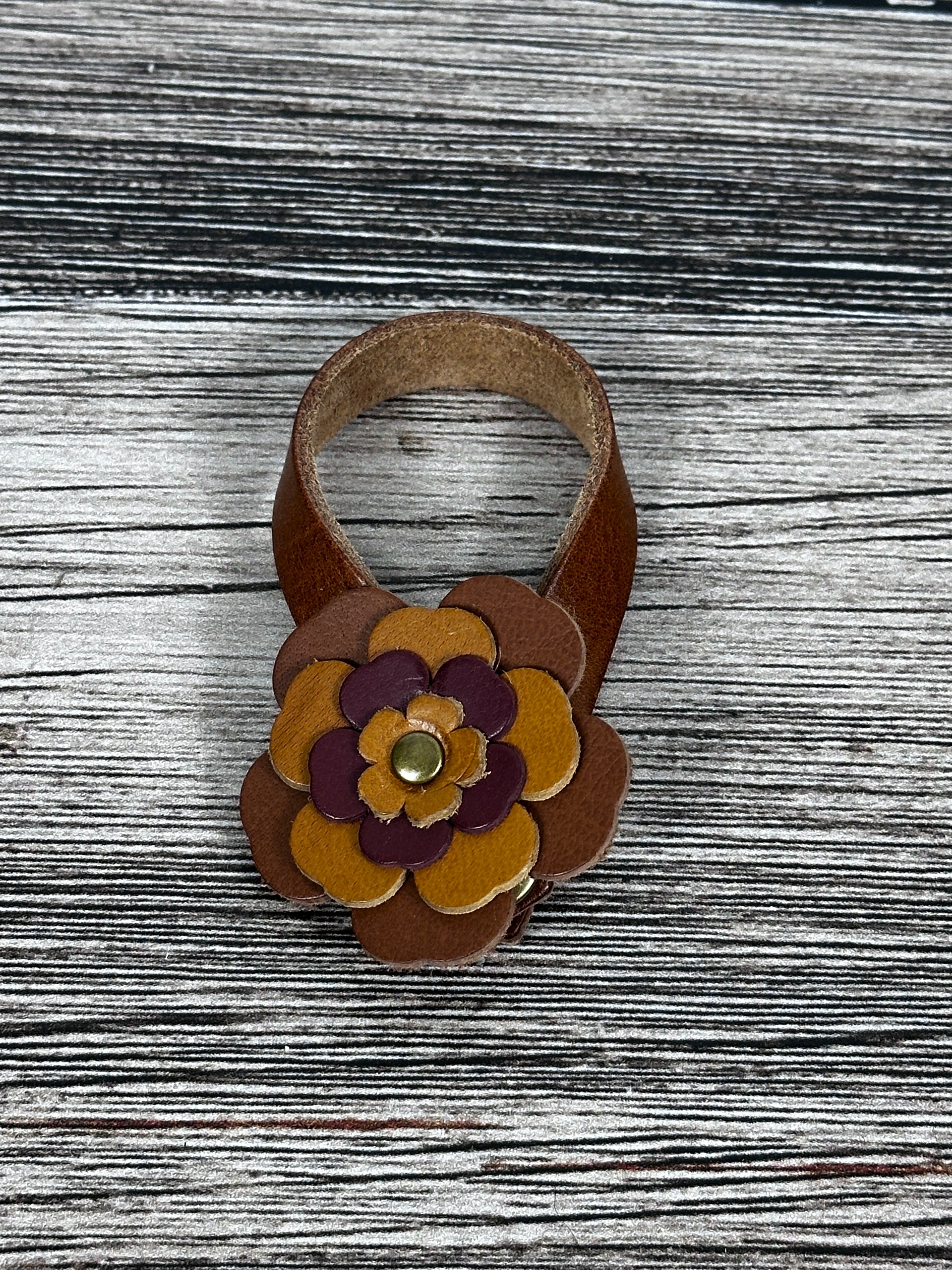 Close-up of leather flower purse charm with snap closure.