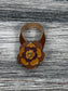 Close-up of leather flower purse charm with snap closure.