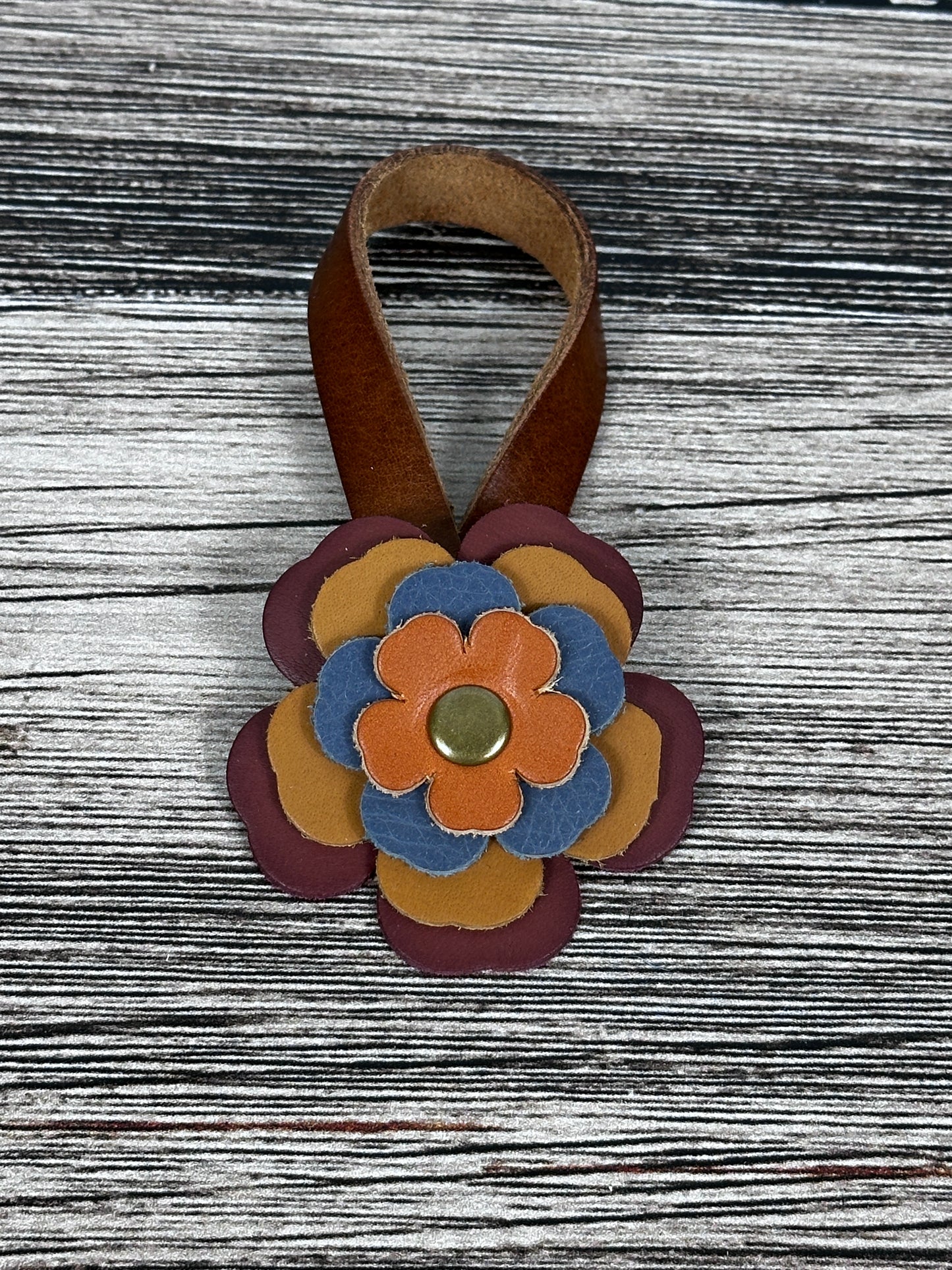 Close-up of leather flower purse charm with snap closure.