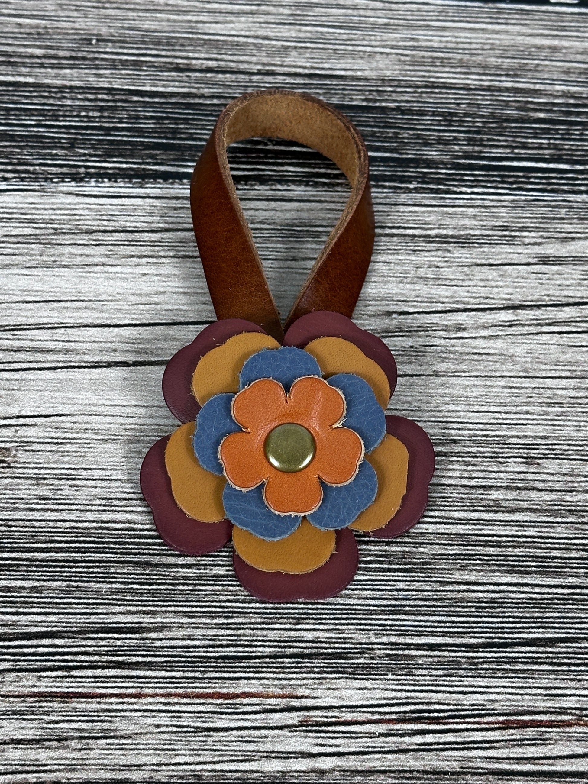 Close-up of leather flower purse charm with snap closure.
