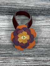 Close-up of leather flower purse charm with snap closure.