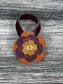 Close-up of leather flower purse charm with snap closure.