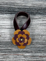 Close-up of leather flower purse charm with snap closure.