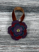 Close-up of leather flower purse charm with snap closure.