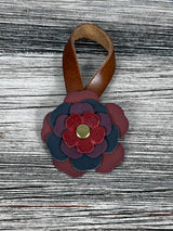 Close-up of leather flower purse charm with snap closure.