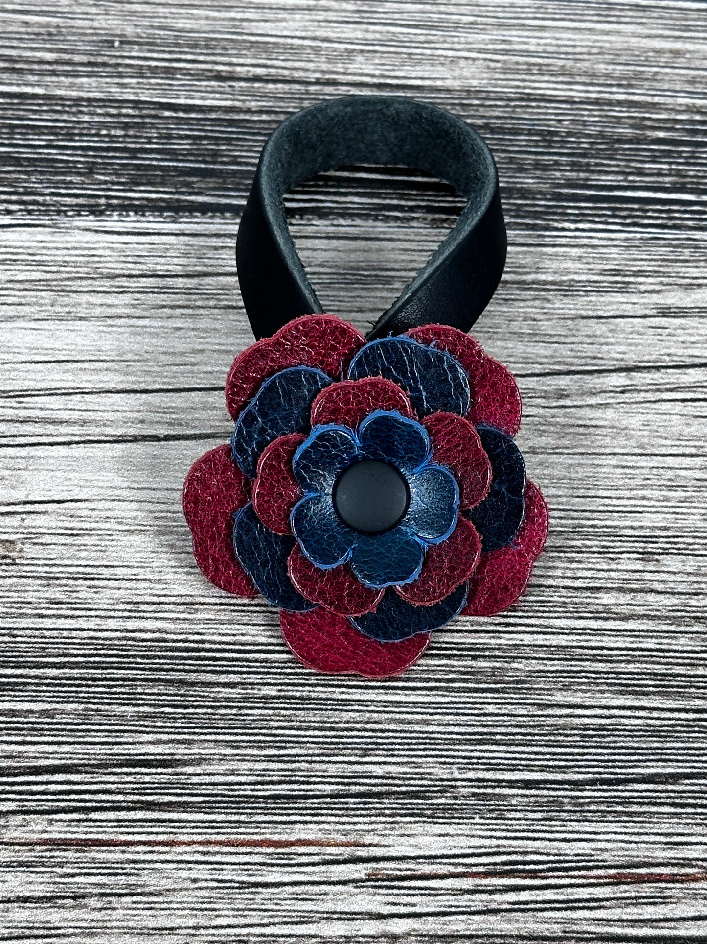 Close-up of leather flower purse charm with snap closure.