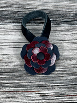 Close-up of leather flower purse charm with snap closure.