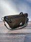 Minimalist sling bag handcrafted with Olive plaid Harris Tweed® and Horween Black Leather, finished with Antique Brass hardware.