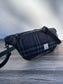 Minimalist sling bag handcrafted with Blue, Black and Grey plaid Harris Tweed® and Horween Black Leather, finished with Matte Black hardware.