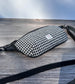 Minimalist sling bag handcrafted with Black and White Houndstooth Harris Tweed® and Horween Black Leather, finished with Matte Black hardware.