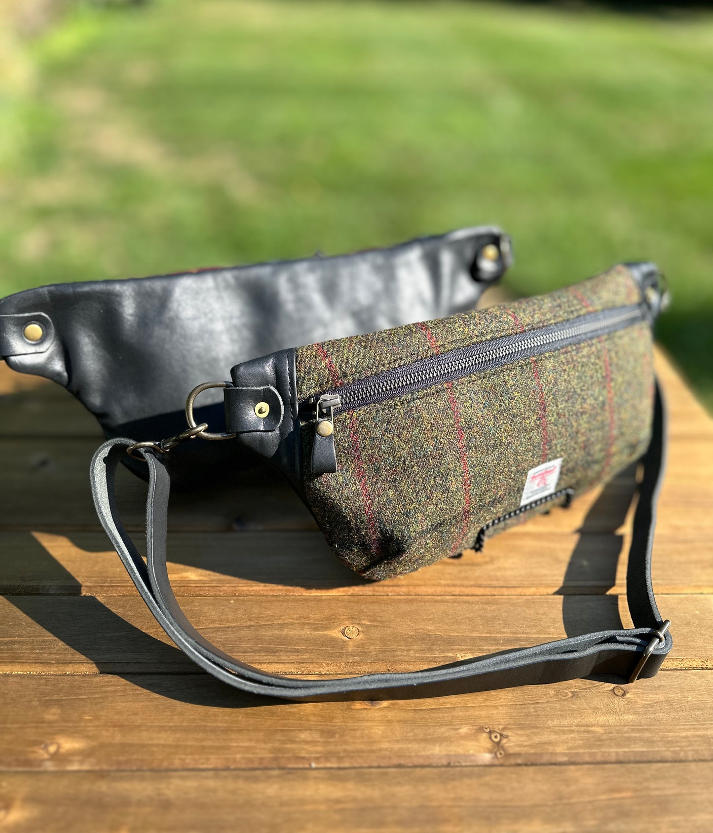 Minimalist sling bag handcrafted with Olive plaid Harris Tweed® and Horween Black Leather, finished with Antique Brass hardware.