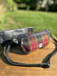 Minimalist sling bag handcrafted with Green, Red and Black plaid Harris Tweed® and Horween Black Leather, finished with Antique Brass  hardware.
