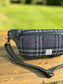 Minimalist sling bag handcrafted with Blue, Black and Grey plaid Harris Tweed® and Horween Black Leather, finished with Matte Black hardware.
