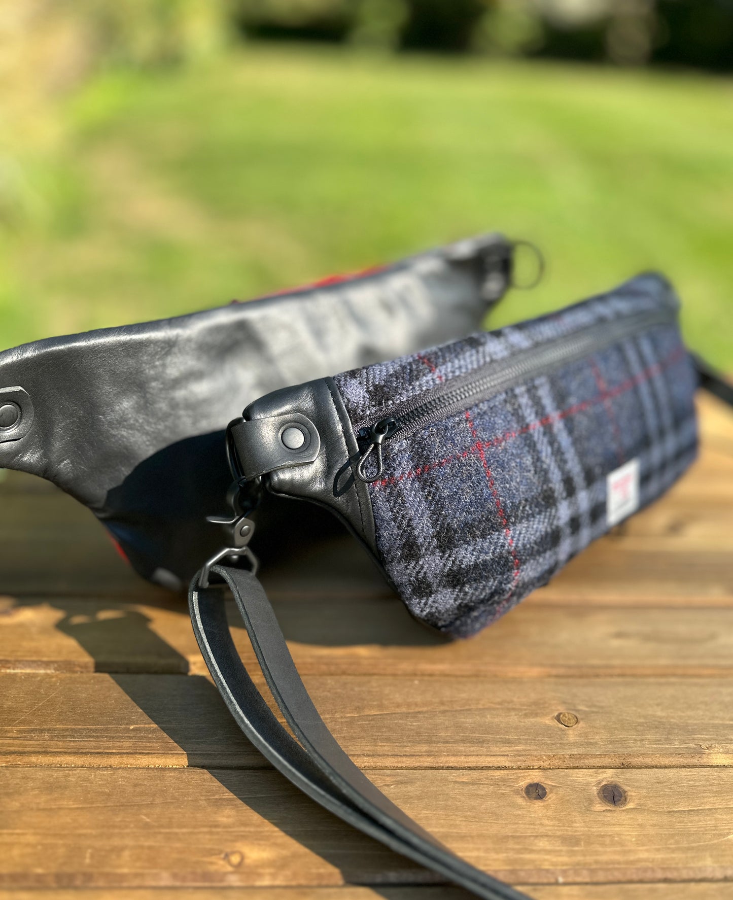 Minimalist sling bag handcrafted with Blue, Black and Grey plaid Harris Tweed® and Horween Black Leather, finished with Matte Black hardware.