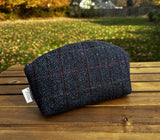 The Seashell Pouch in Navy Window Pane Harris Tweed® has a curved top and flat base that stands up on its own, lined with natural heavy canvas.