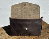 Interior view of an open Skye Fold clutch in Brown and Beige Herringbone Harris Tweed® with Espresso Leather. The interior is spacious enough to fit a phone and daily essentials.