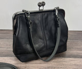 Handcrafted full-grain leather Princess Anne Kiss Lock handbag featuring a vintage-style frame and convertible straps.