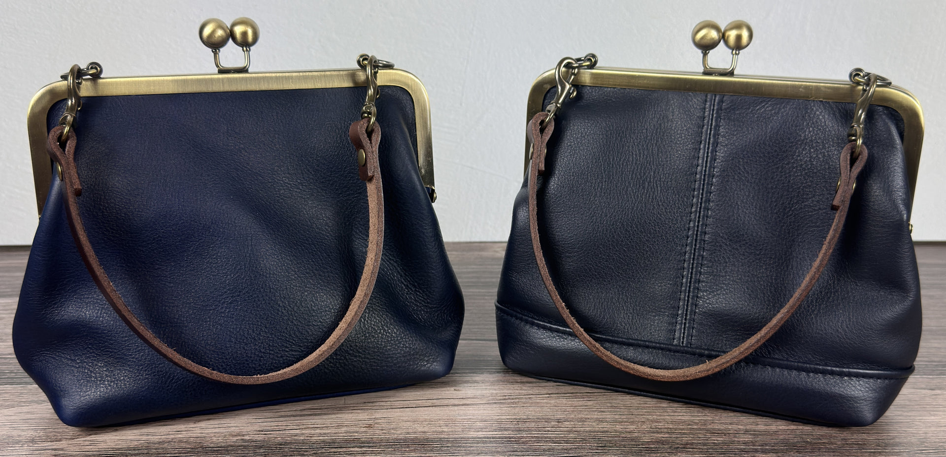 Two Handcrafted full-grain leather Princess Anne Kiss Lock handbag featuring a vintage-style frame and convertible straps.