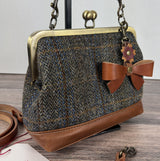 Harris Tweed® Princess Anne Kiss Lock Purse in Green Blue Herringbone with leather base, handbag strap, and crossbody strap — shown with a Leather Bow Trinket.