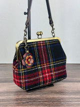 Leather flower bag charm on Harris Tweed Kiss Lock Bag – handcrafted leather accessory.