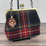 Leather flower bag charm on Harris Tweed Princess Anne Kiss Lock Bag – handcrafted leather accessory.
