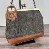 Leather flower bag charm on Harris Tweed Princess Anne Kiss Lock Bag – handcrafted leather accessory.