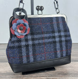 Leather flower bag charm on Harris Tweed Princess Anne Kiss Lock Bag – handcrafted leather accessory.