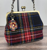 Leather flower bag charm on Harris Tweed Princess Anne Kiss Lock Bag – handcrafted leather accessory.