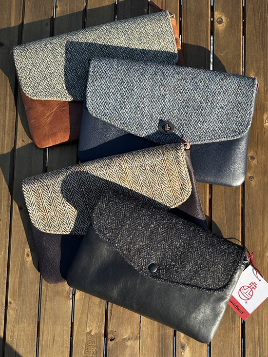 Overhead view of the Skye Fold collection, demonstrating the sleek, structured silhouette and effortless elegance. Each clutch features a beautifully tailored Harris Tweed flap and a secure magnetic snap closure.