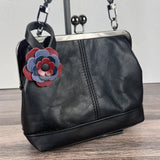 Leather flower bag charm on Black Leather Princess Anne Kiss Lock Bag – handcrafted leather accessory.