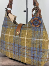 Leather flower bag charm on Harris Tweed Rhode River Shoulder Bag – handcrafted leather accessory.