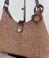 Leather flower bag charm on Harris Tweed Rhode River Shoulder Bag – handcrafted leather accessory.