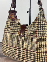 Leather flower bag charm on Harris Tweed Rhode River Shoulder Bag – handcrafted leather accessory.