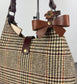 Leather bow bag charm clipped to Harris Tweed Rhode River Shoulder bag – handcrafted purse accessory cut by hand.