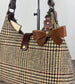 Leather bow bag charm clipped to Harris Tweed Rhode River Shoulder bag – handcrafted purse accessory cut by hand.