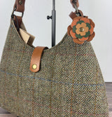 Leather flower bag charm on Harris Tweed Rhode River Shoulder Bag – handcrafted leather accessory.