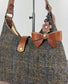 Leather bow bag charm clipped to Harris Tweed Rhode River Shoulder bag – handcrafted purse accessory cut by hand.