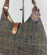 Leather flower bag charm on Harris Tweed Rhode River Shoulder Bag – handcrafted leather accessory.