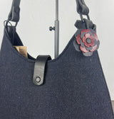 Leather flower bag charm on Harris Tweed Rhode River Shoulder Bag – handcrafted leather accessory.