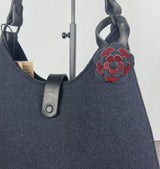 Leather flower bag charm on Harris Tweed Rhode River Shoulder Bag – handcrafted leather accessory.