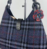 Leather flower bag charm on Harris Tweed Rhode River Shoulder Bag – handcrafted leather accessory.