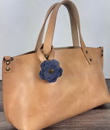 Leather flower bag charm on Leather Tote Bag – handcrafted leather accessory.