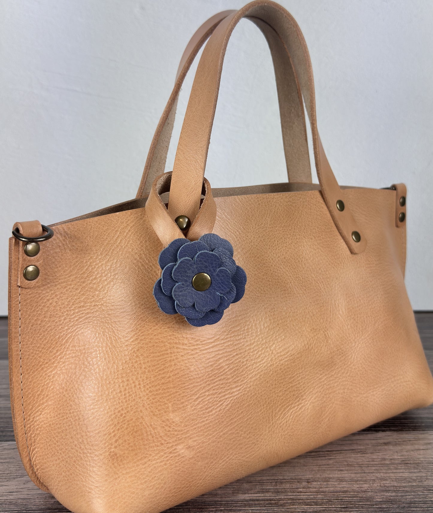 Leather flower bag charm on Leather Tote Bag – handcrafted leather accessory.