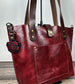 Red leather handbag with decorative leather flower charm.  