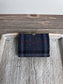 Closed Mini Harris Tweed® Rock Hall Wallet in Dark Navy, Grey, Black Plaid, featuring Gunmetal flip-lock closure.