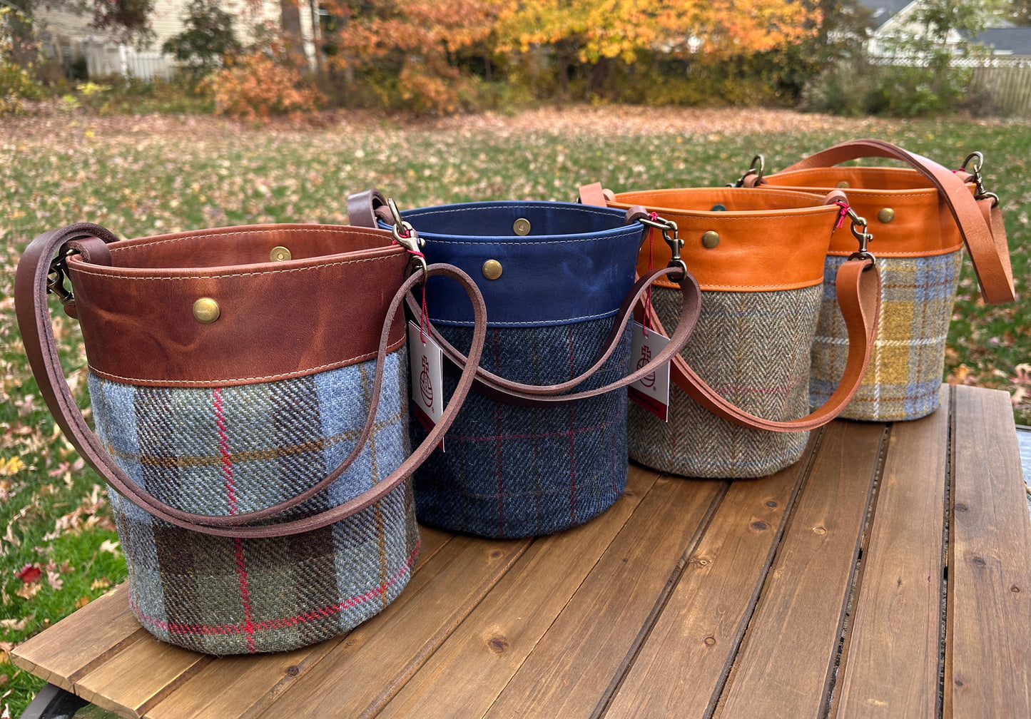 Four Harris Tweed® Lighthouse Crossbody round bag with flat bottom and leather accents